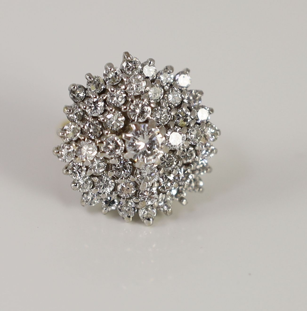 An impressive gold, platinum and diamond set circular cluster ring